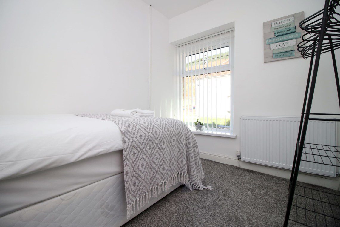Single bedroom with storage and clothes hanging space