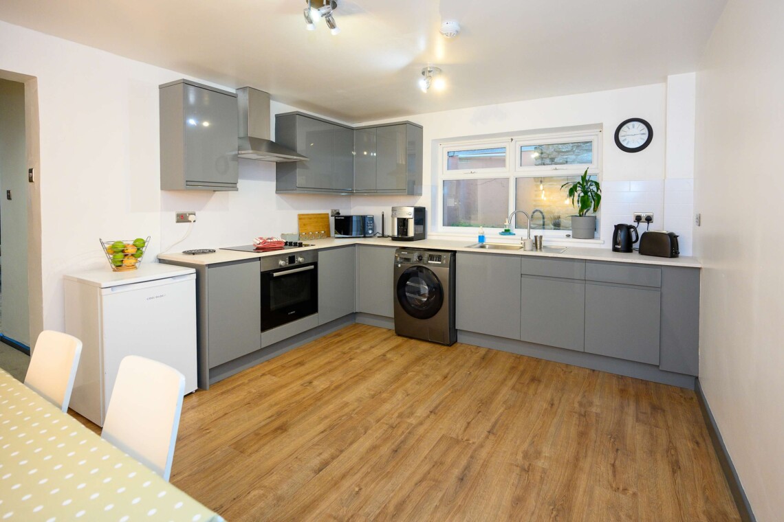 Open plan living area which contains comfortable sofa where you can relax watching the widescreen smart TV.