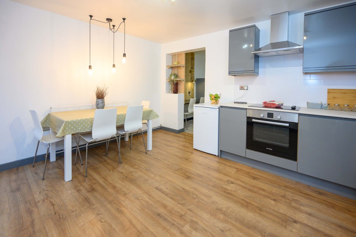 Open plan living area which contains comfortable sofa where you can relax watching the widescreen smart TV.