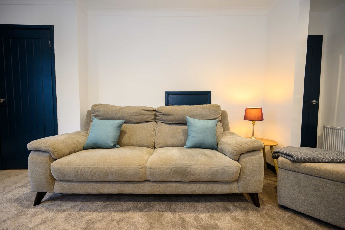 Open plan living area which contains comfortable sofa where you can relax watching the widescreen smart TV.