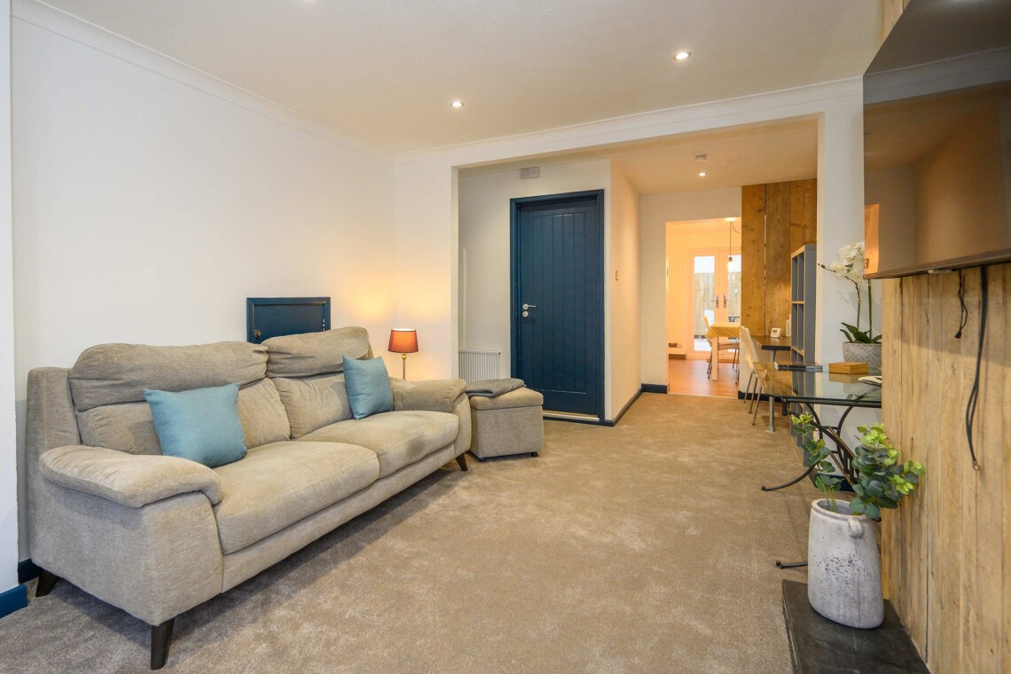 Open plan living area which contains comfortable sofa where you can relax watching the widescreen smart TV.