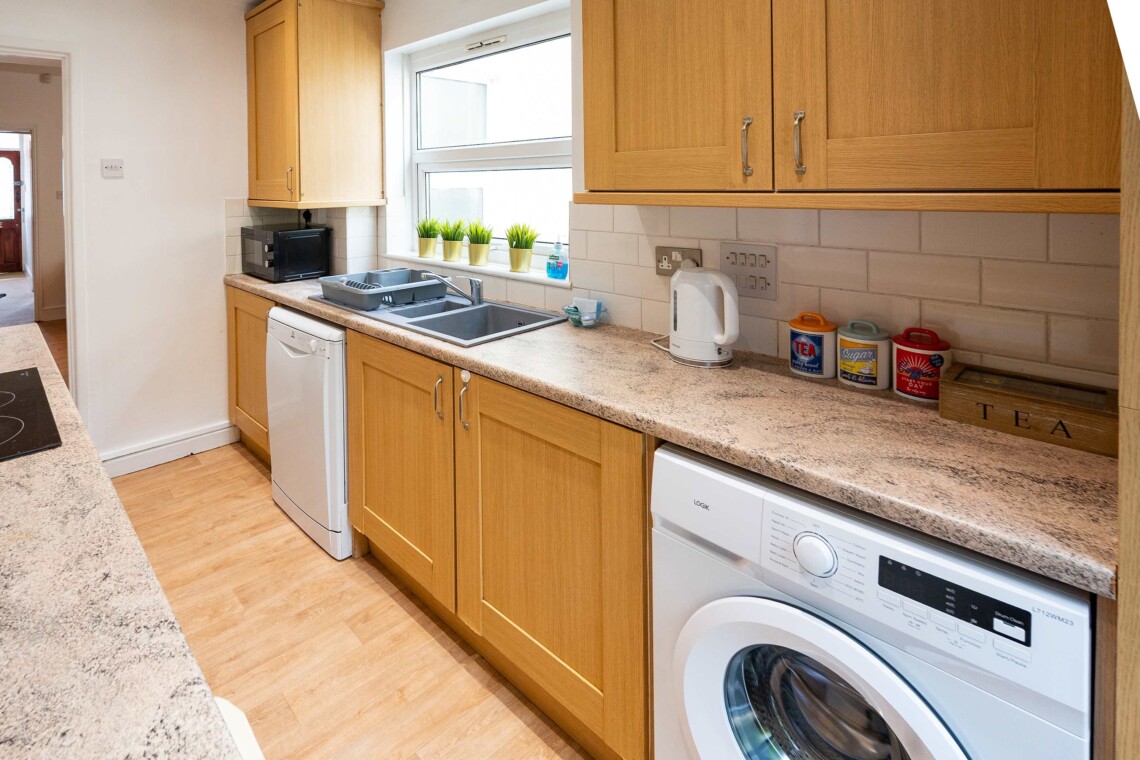 fully equipped kitchen provides all essential amenities, including a hob, oven, crockery, toaster, kettle, washer, and a coffee machine