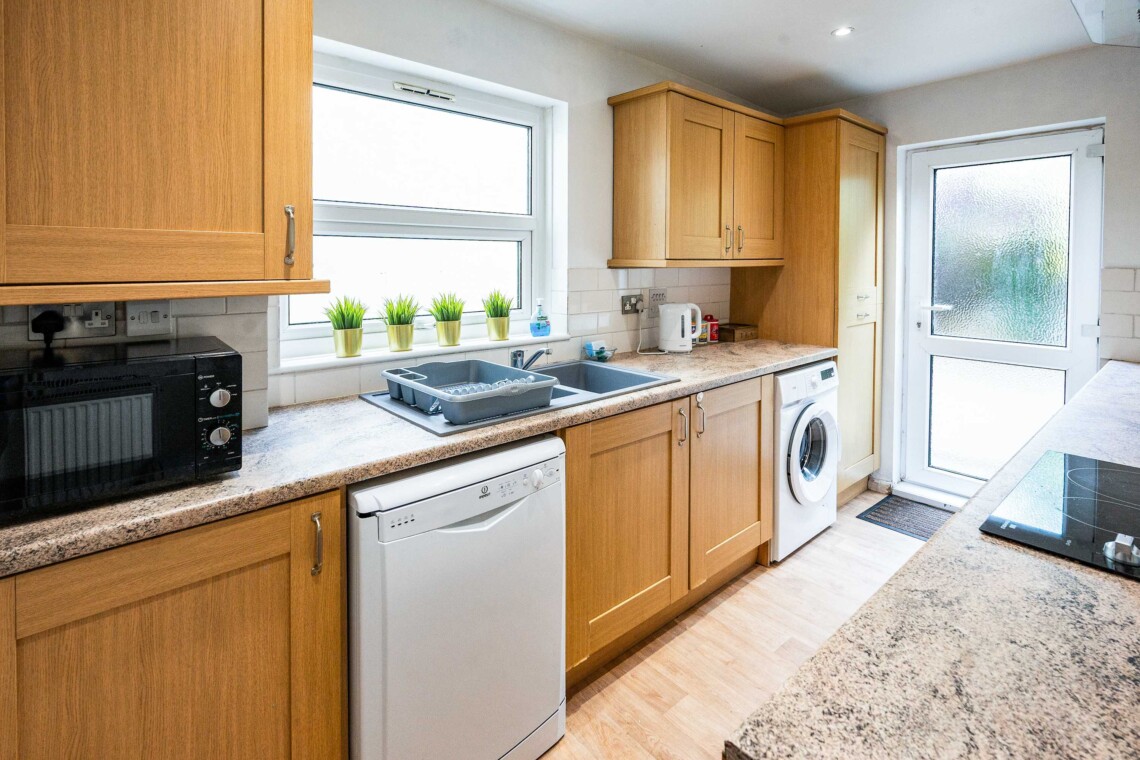 fully equipped kitchen provides all essential amenities, including a hob, oven, crockery, toaster, kettle, washer, and a coffee machine