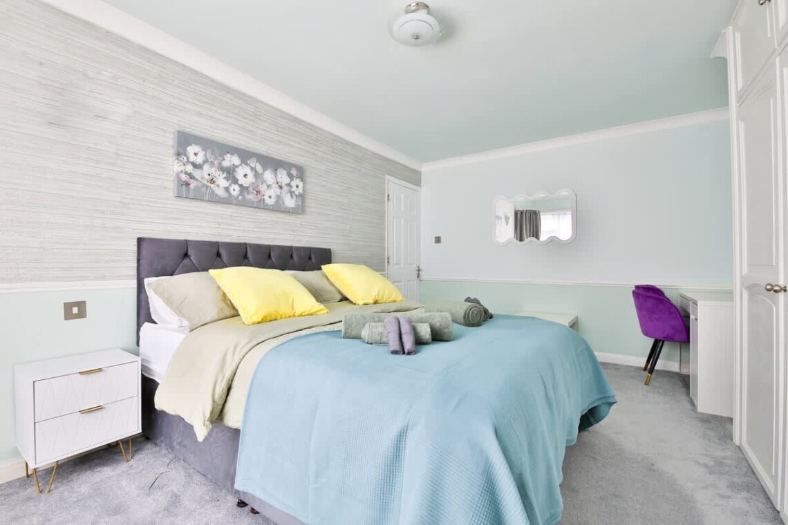 Spacious and bright, with a king-size bed and a convenient work area.
