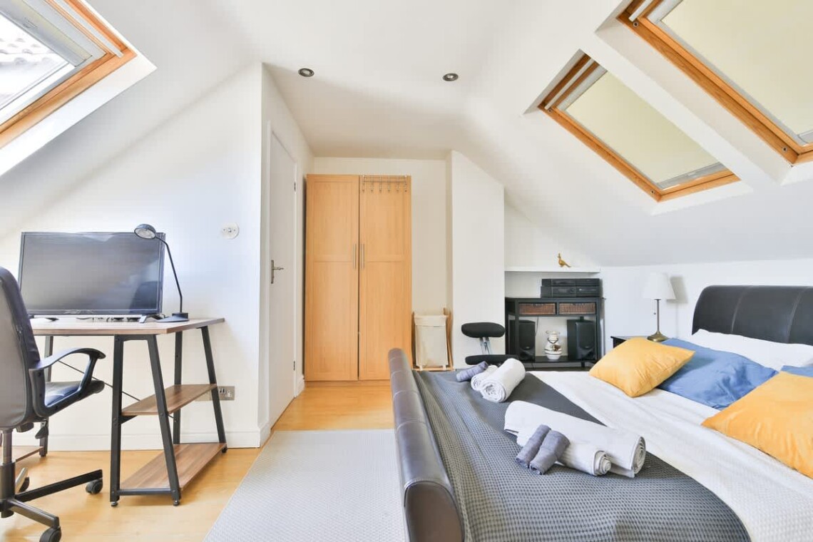 A large, private retreat with a king-size bed and a desk