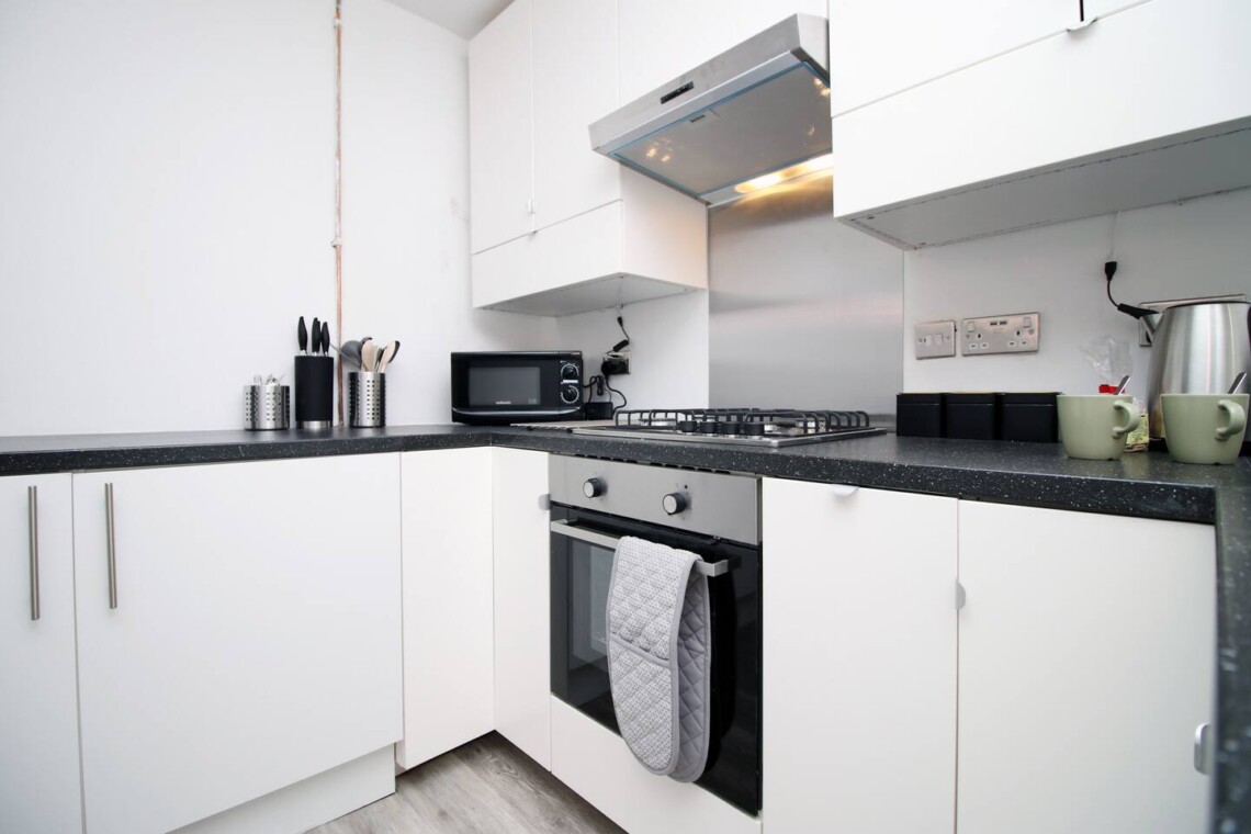 The fully equipped kitchen is ready for your culinary adventures, with everything you need to make delicious homemade meals. 