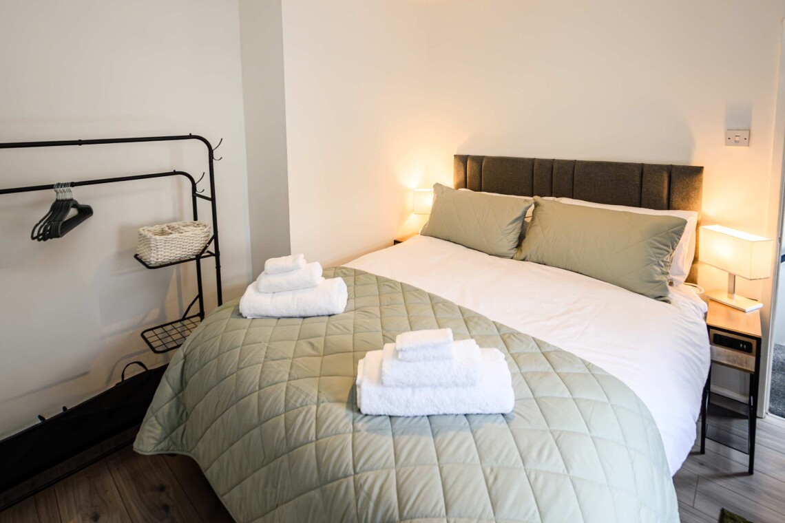 Main bedroom with kingsized bed, bedside table with USB charging sockets