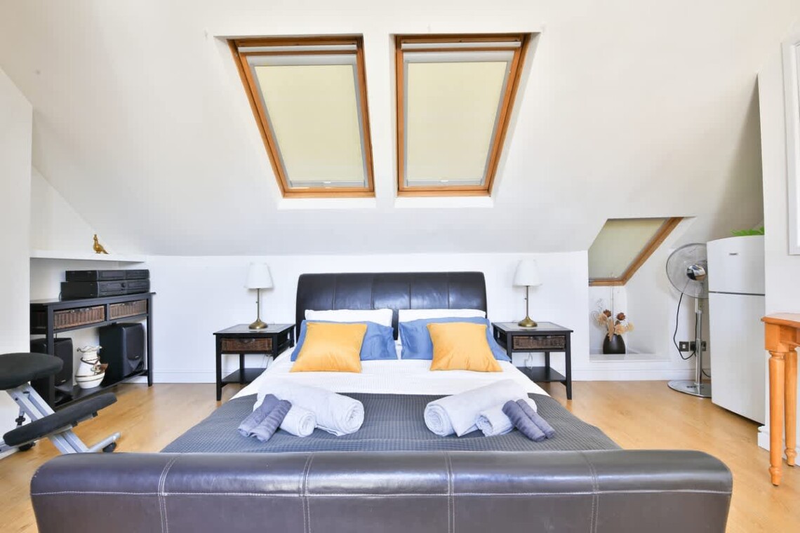 Top floor with a king-size bed, desk, and mini fridge—ideal for longer stays or added privacy.