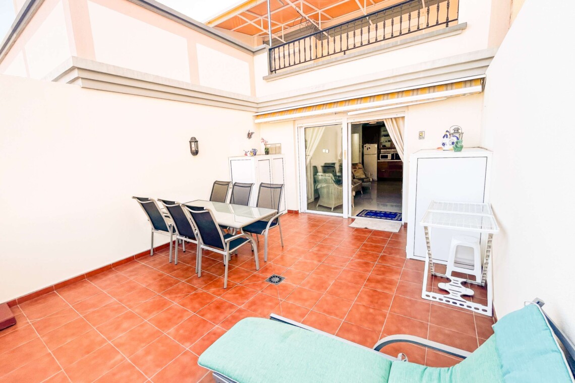 Large patio area with table and seating area