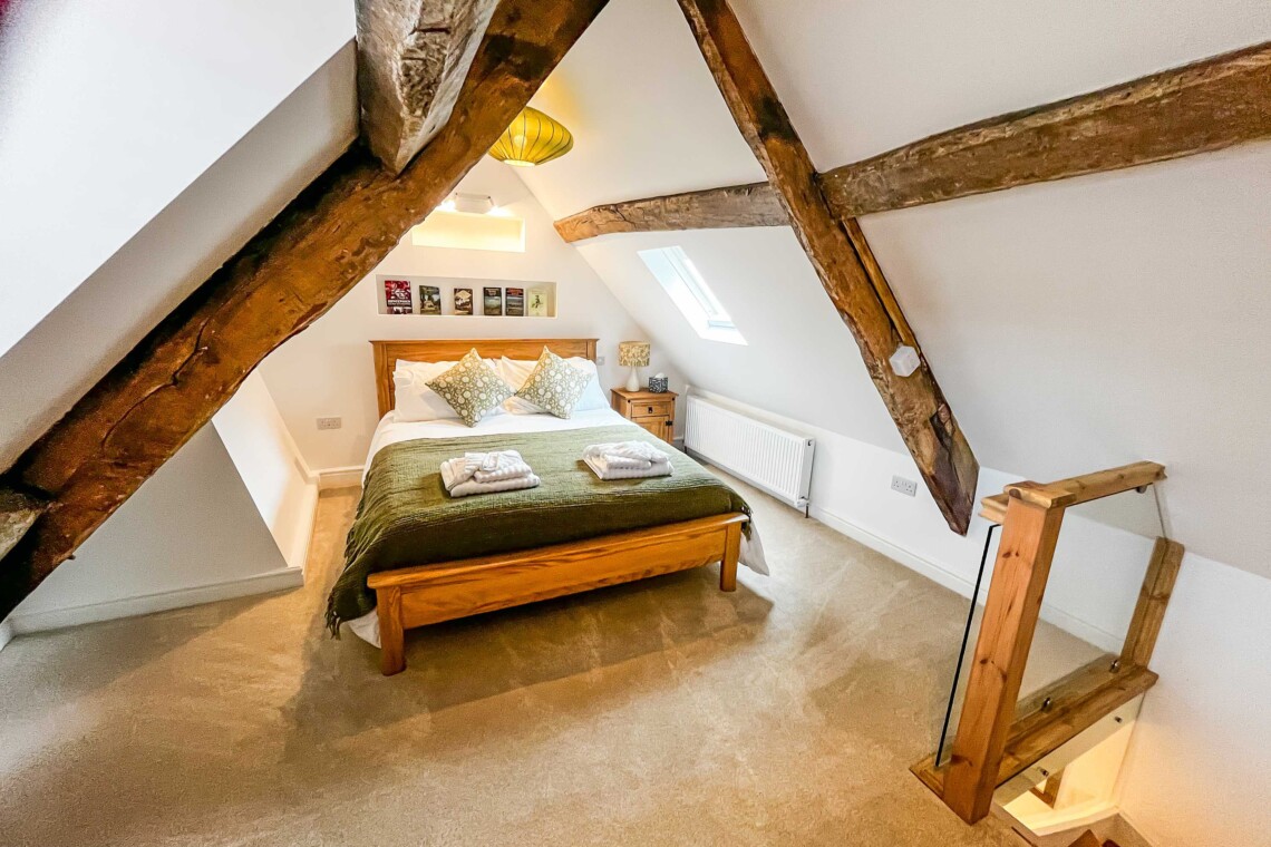 King size bed under the wooden beams