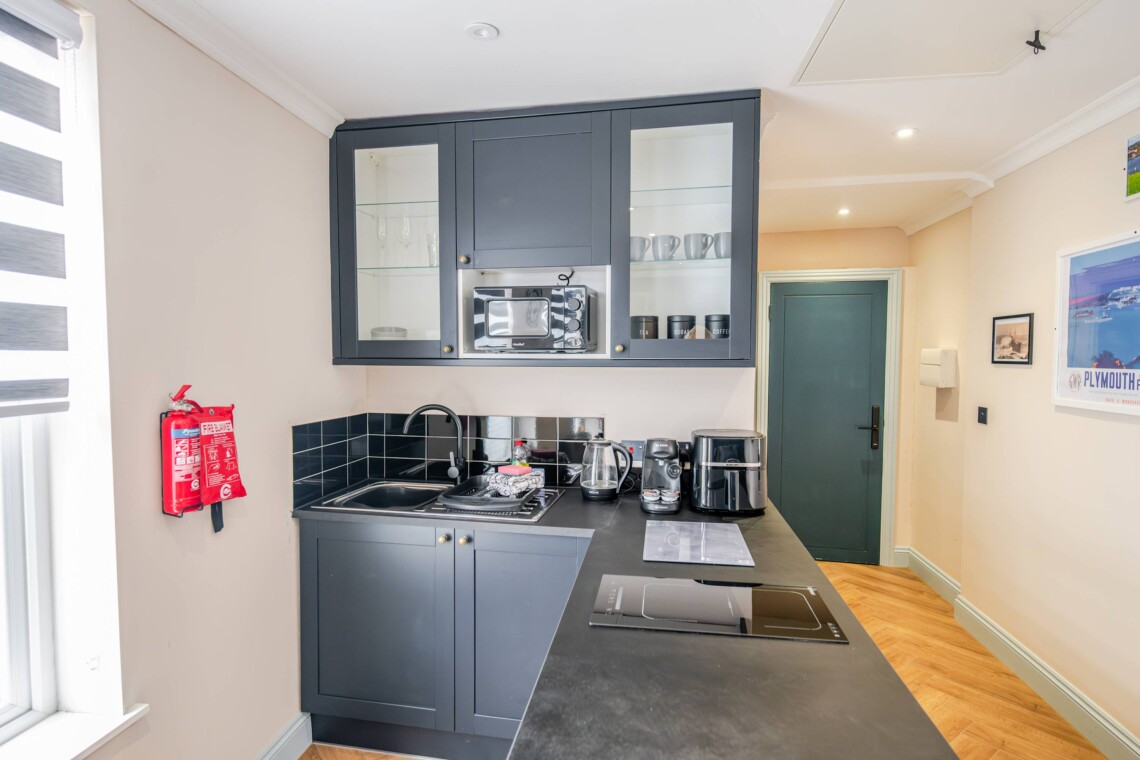 The apartment features a single-level layout with an open-plan living area and kitchen.