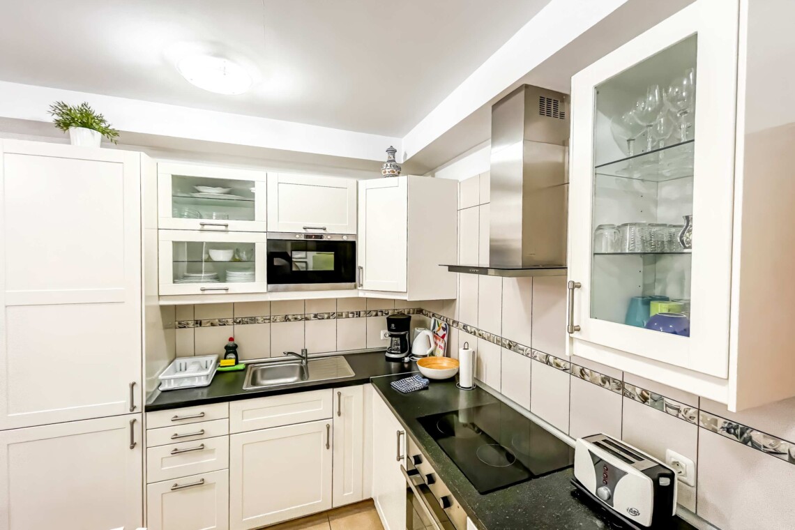 A fully equipped kitchen allows you to prepare your own meals. It includes a coffee maker, cookware, dishes, silverware, microwave, oven, and refrigerator. 