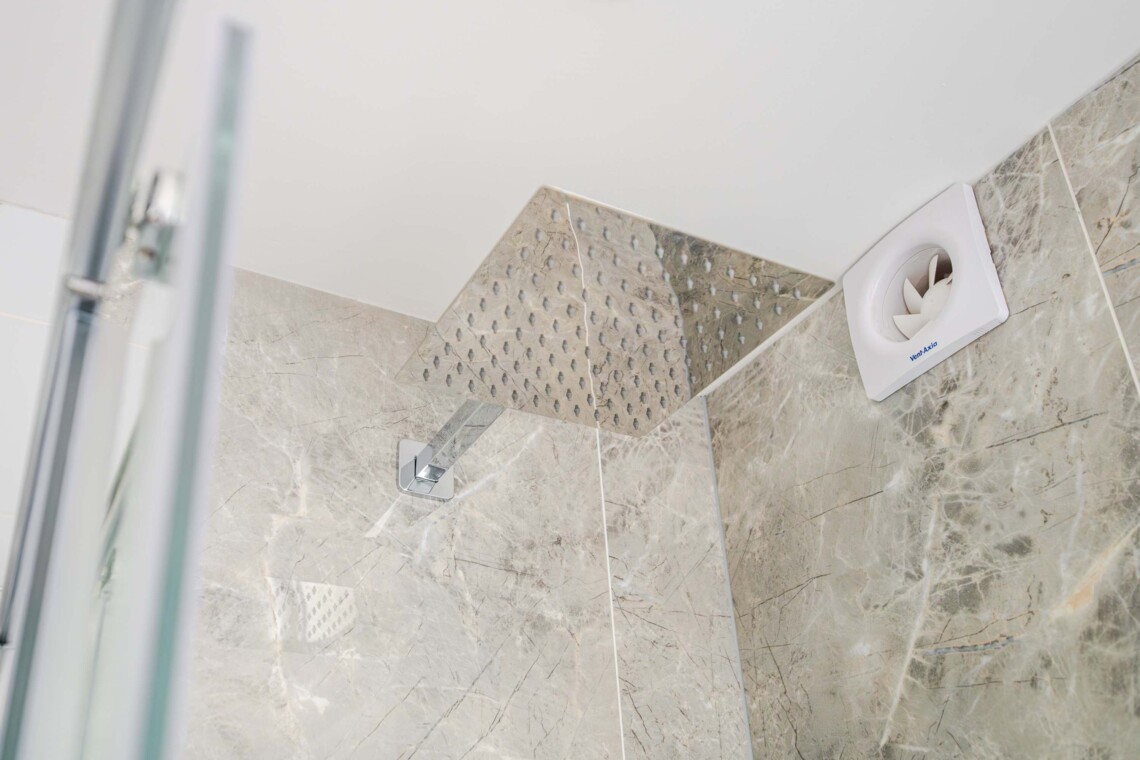 Modern shower room, equipped with contemporary fixtures and amenities for your convenience, such as a walk-in shower and ample storage space.