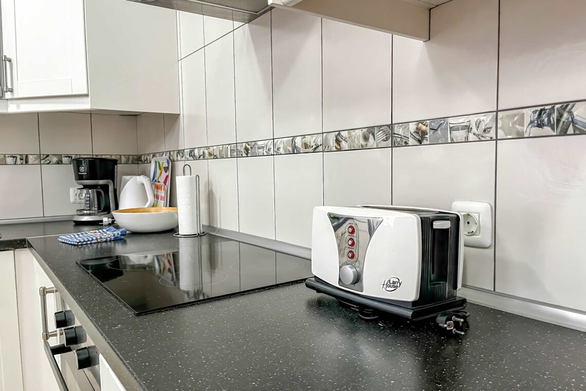 Coffee maker, cookware, dishes, silverware, microwave, oven, and refrigerator. 