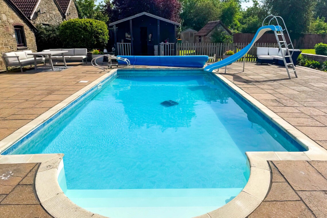 Enjoy summer by the private pool, complete with a fun slide. The massive patio features plenty of outdoor furniture, making it the perfect countryside escape for al fresco dining, sunbathing, and total relaxation.