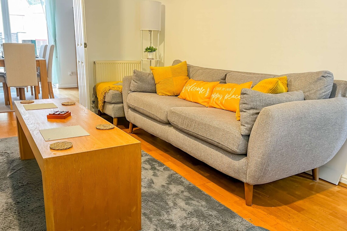 Unwind in the spacious living room, featuring two plush sofas and a central coffee table. The perfect spot to gather for movie nights, share conversation, or relax after a busy day