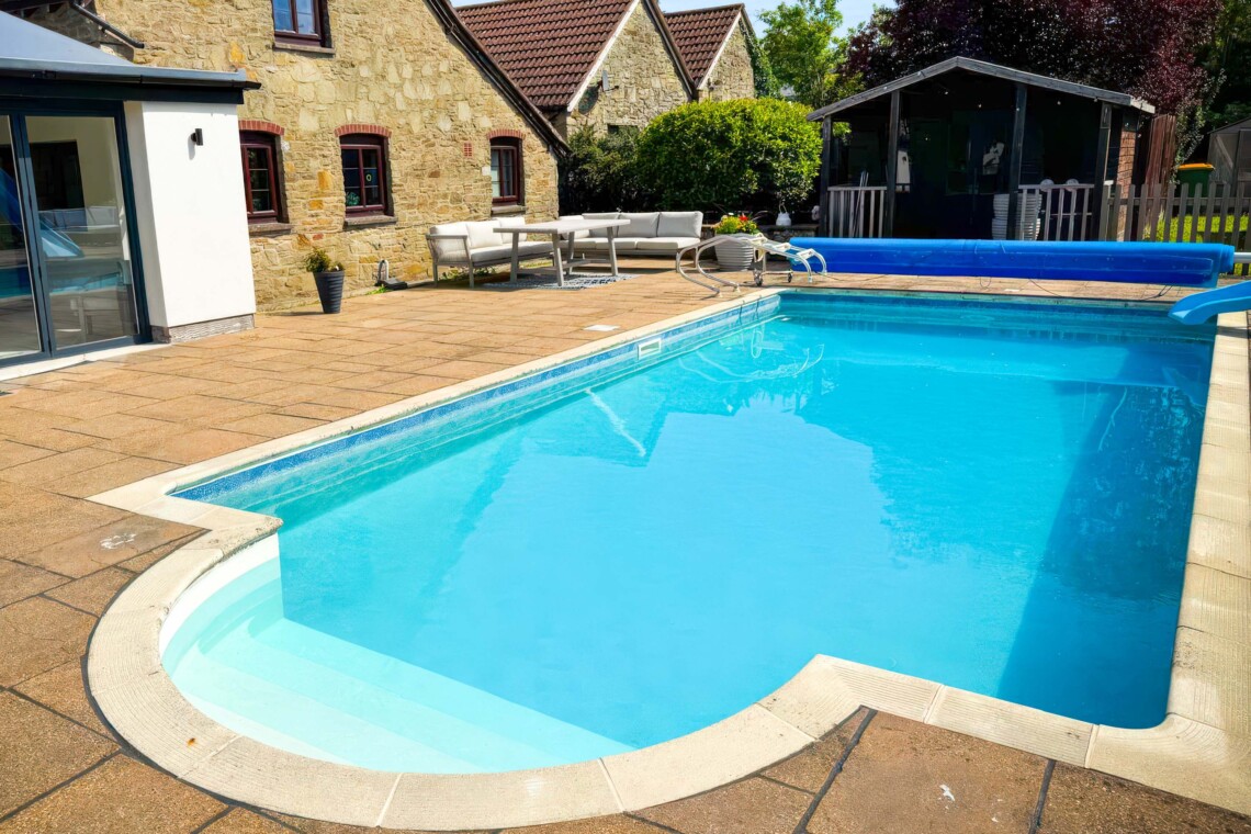 Enjoy summer by the private pool, complete with a fun slide. The massive patio features plenty of outdoor furniture, making it the perfect countryside escape for al fresco dining, sunbathing, and total relaxation.