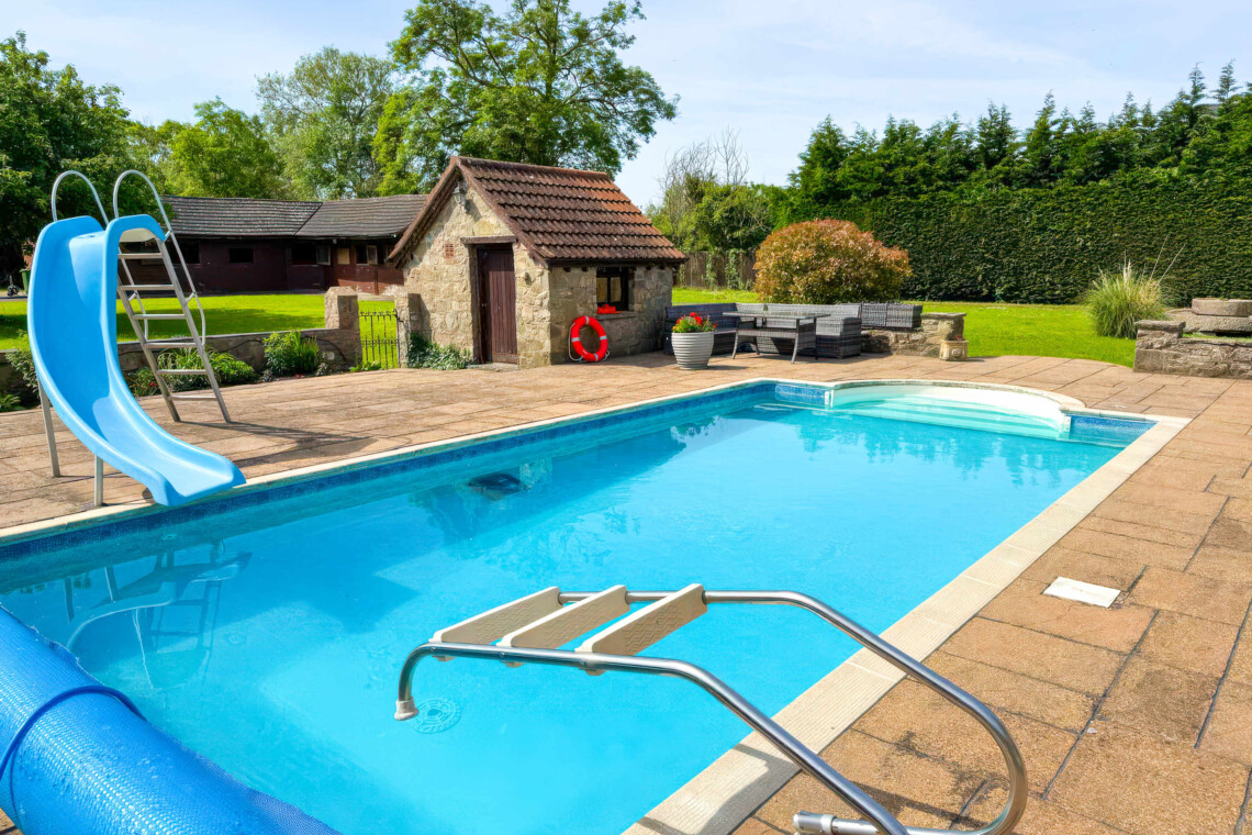 Enjoy summer by the private heated pool, complete with a fun slide. The massive patio features plenty of outdoor furniture, making it the perfect countryside escape for al fresco dining, sunbathing, and total relaxation.