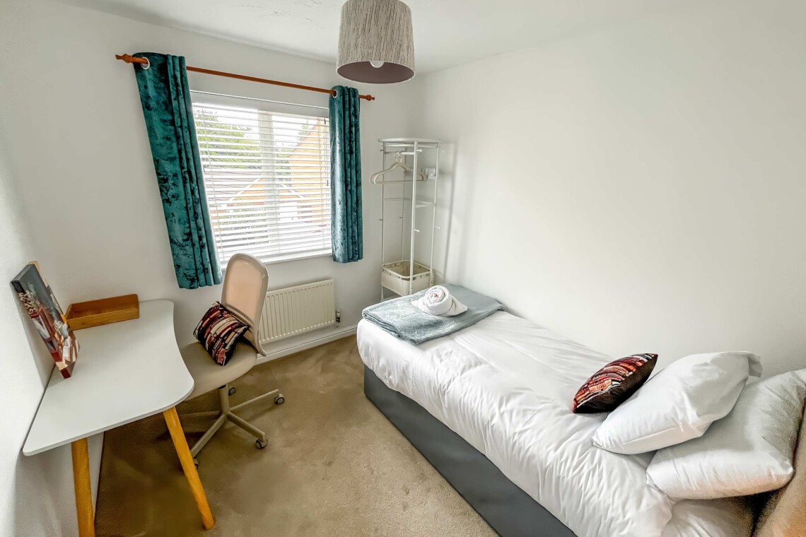 Bedroom four includes a cosy single bed, a small desk, and a supportive computer chair. Ideal for catching up on emails or relaxing in peace.