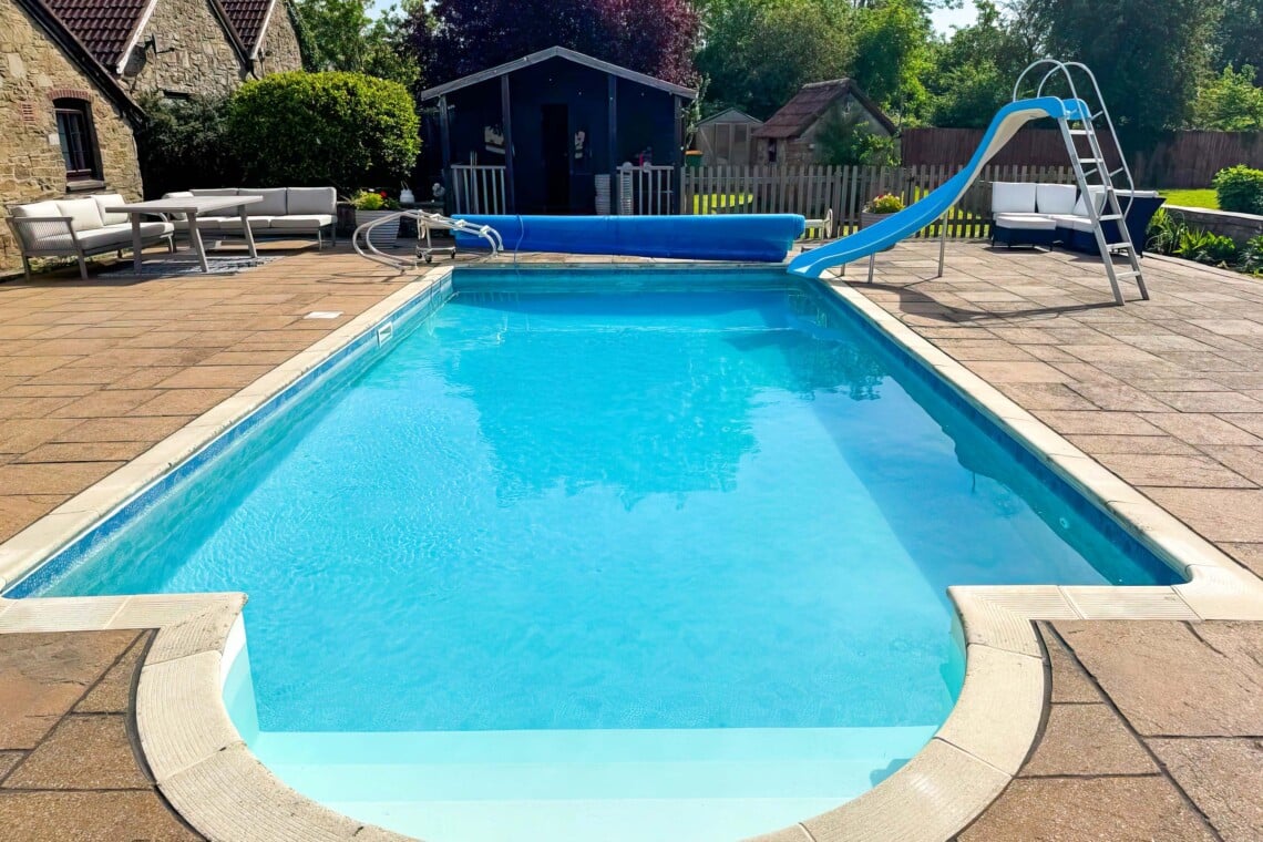 Enjoy summer by the private heated pool, complete with a fun slide. The massive patio features plenty of outdoor furniture, making it the perfect countryside escape for al fresco dining, sunbathing, and total relaxation.