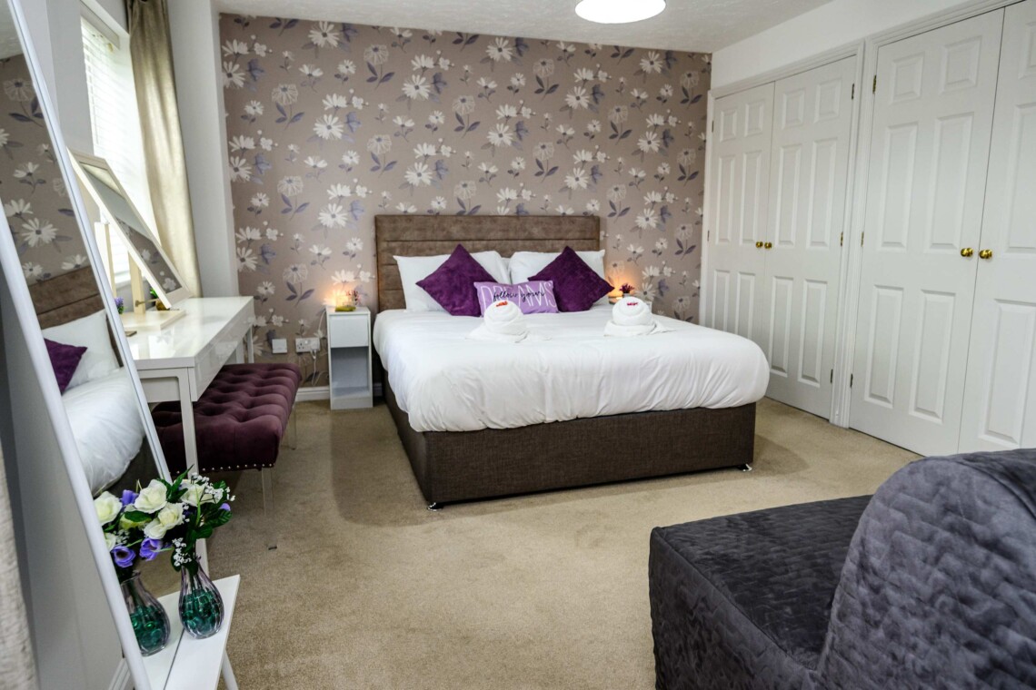 The spacious main bedroom features a beautifully styled wallpapered wall that gives the space a boutique-hotel feel. Attached, you will find the convenience of your own private bathroom