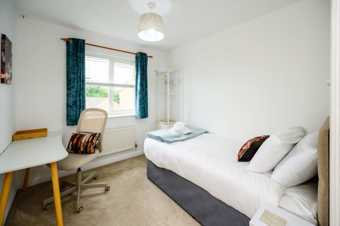 Bedroom four includes a cosy single bed, a small desk, and a supportive computer chair. Ideal for catching up on emails or relaxing in peace.