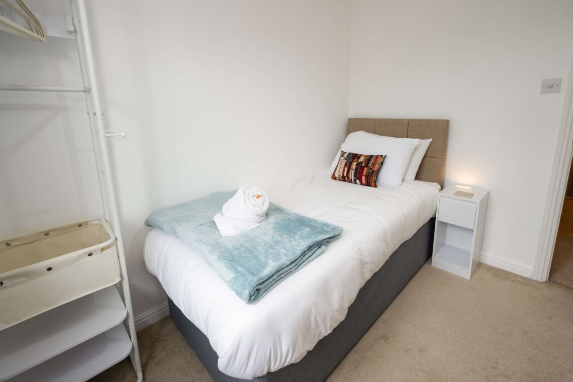 Bedroom four includes a cosy single bed, a small desk, and a supportive computer chair. Ideal for catching up on emails or relaxing in peace.