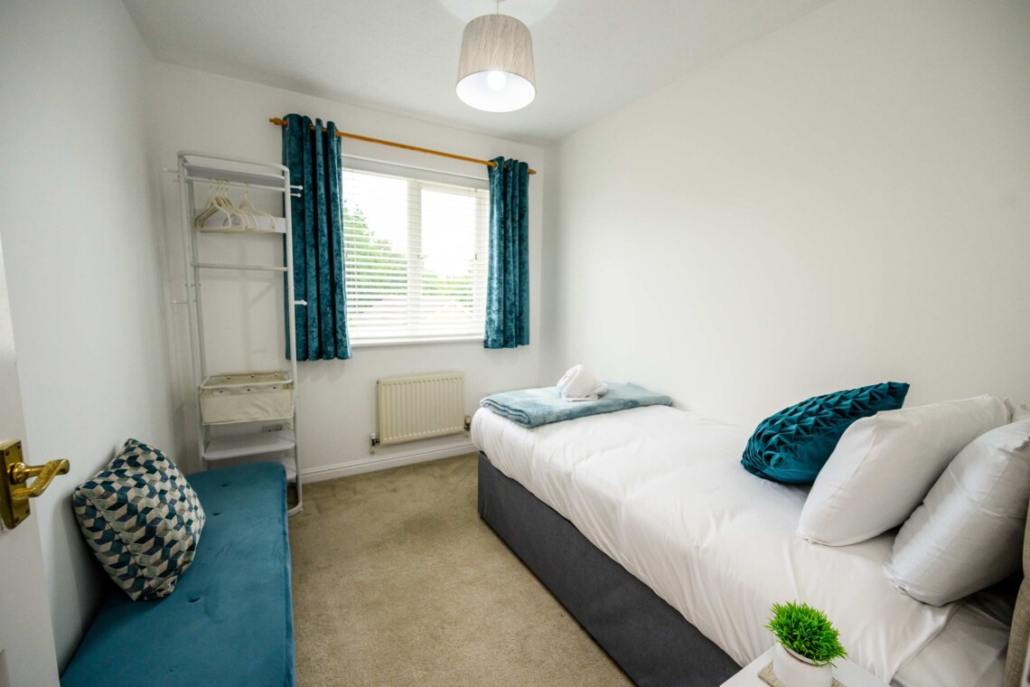 Bedroom three includes a cosy single bed, a small desk, and a supportive computer chair. Ideal for catching up on emails or relaxing in peace.
