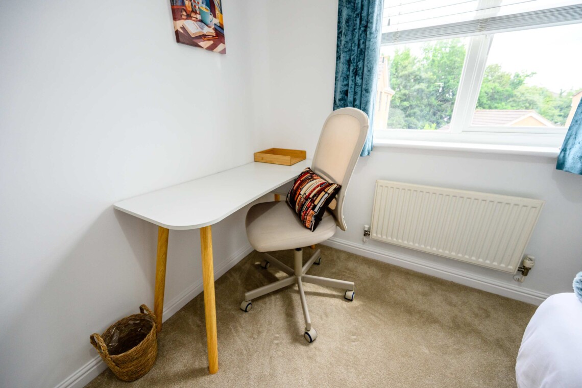 Bedroom four includes a cosy single bed, a small desk, and a supportive computer chair. Ideal for catching up on emails or relaxing in peace.