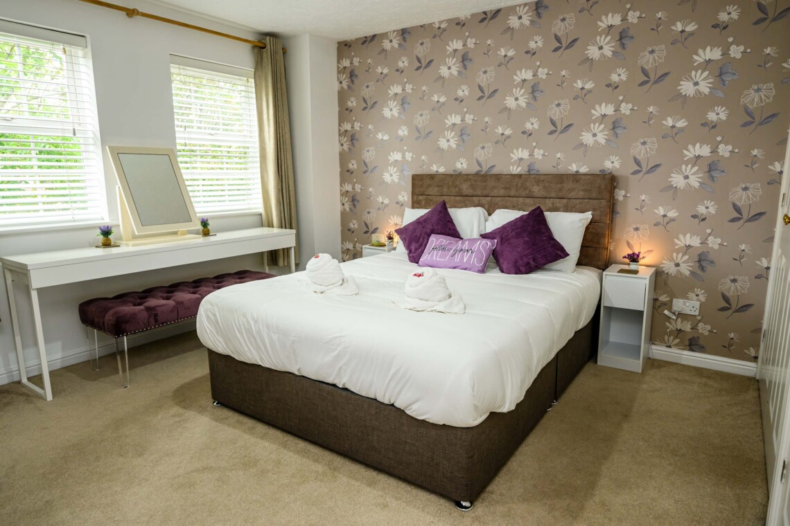The spacious main bedroom features a beautifully styled wallpapered wall that gives the space a boutique-hotel feel. Attached, you will find the convenience of your own private bathroom