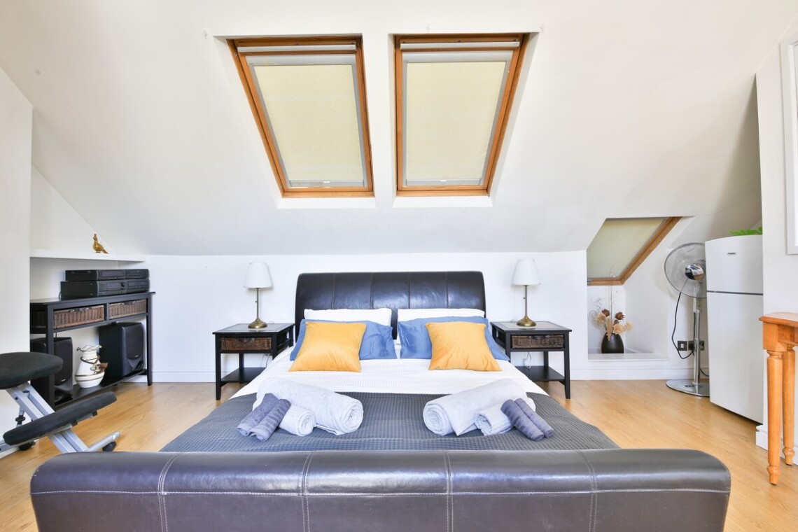 Top floor with a king-size bed, desk, and mini fridge—ideal for longer stays or added privacy.