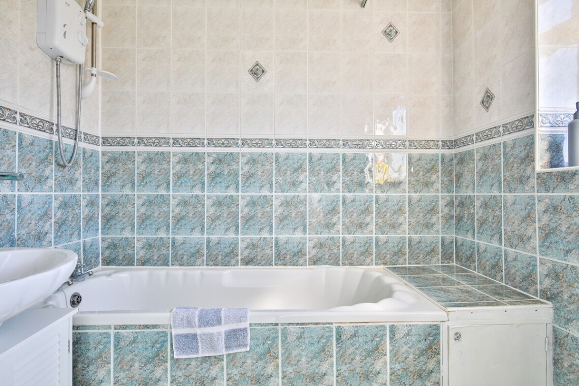 Main bathroom has a large bath and shower over bath