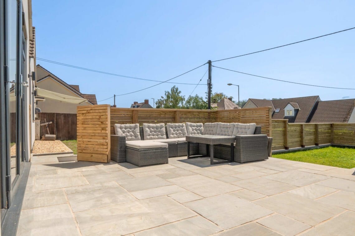 A welcoming front view of the property, featuring a paved driveway and steps leading to the entrance.